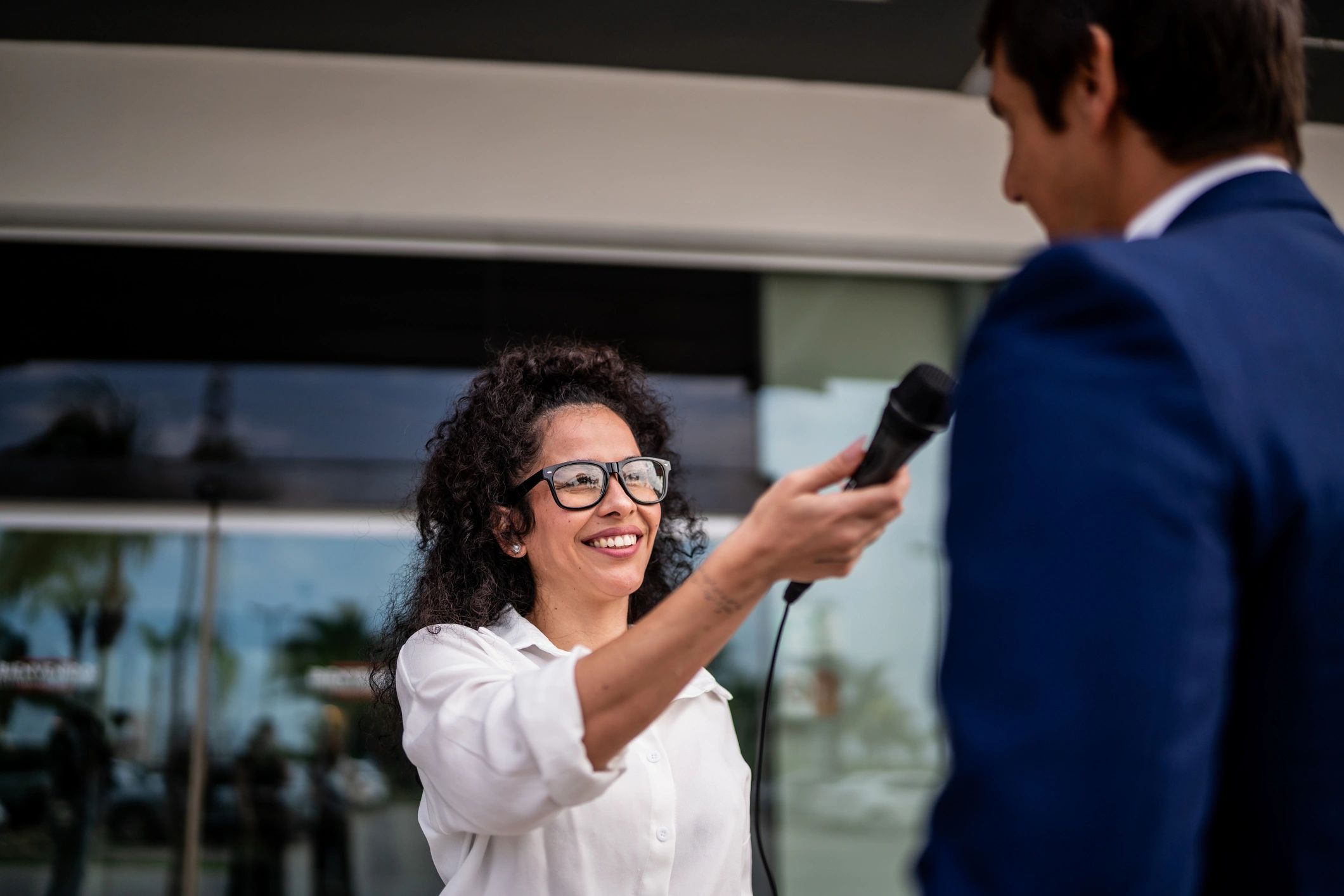 Reporter interviewing a source outdoors